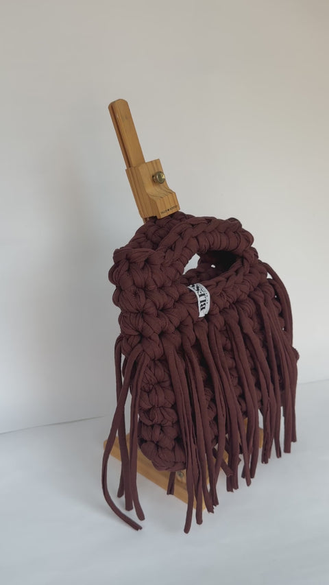 Video of a deep brown crochet Sasha bag with a long fringe